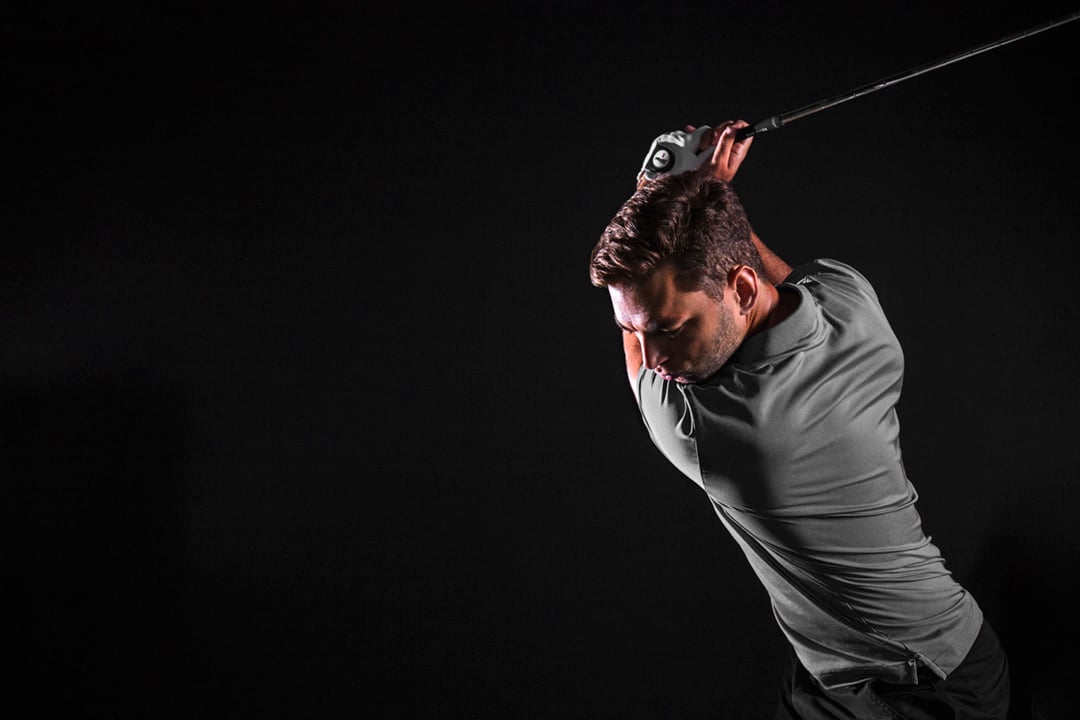 Player swinging on dark background_72 dpi_grey
